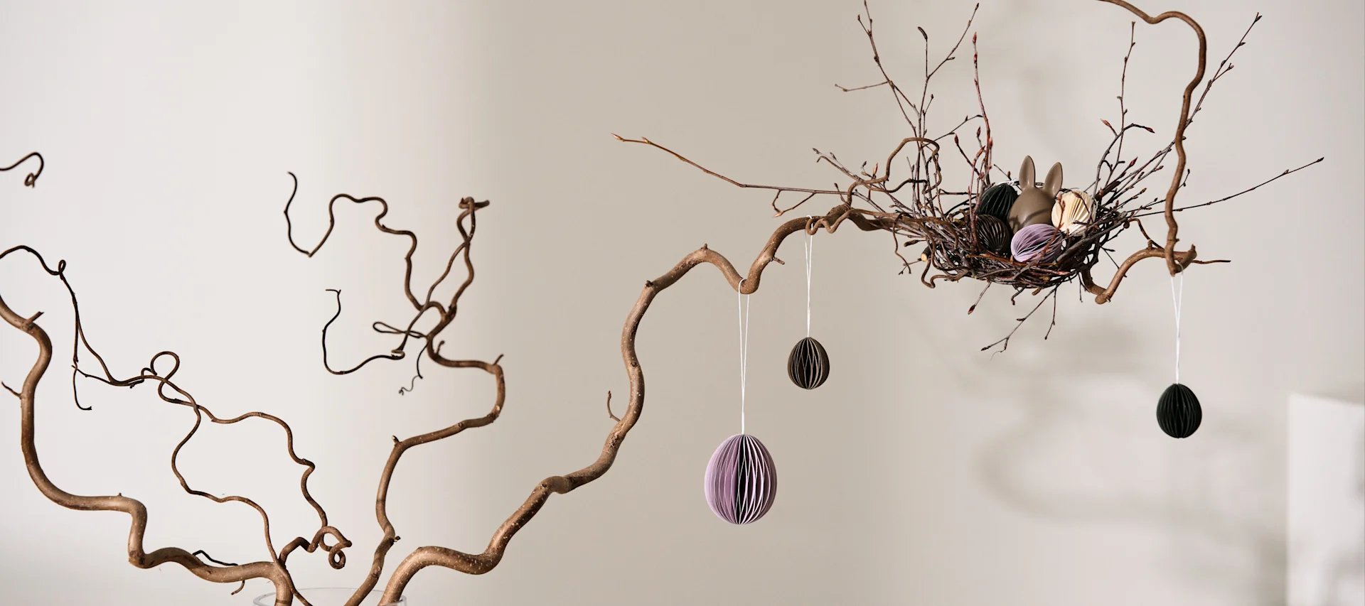 How to make an Easter tree - here you see the DBKD paper egg decorations hanging in the branches of a home made Easter tree.