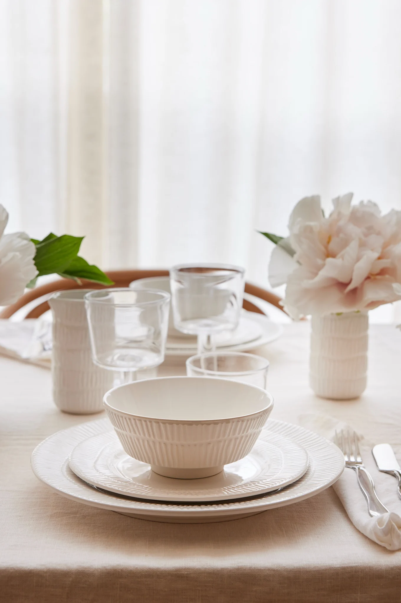 A white table setting, including the Stripes bowl in white from Mateus.